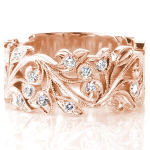 Unique wide wedding band in Denver features an antique inspired floral design. This beautiful rose gold wedding band is edged with a beaded milgrain texture and is set with brilliant round diamonds.