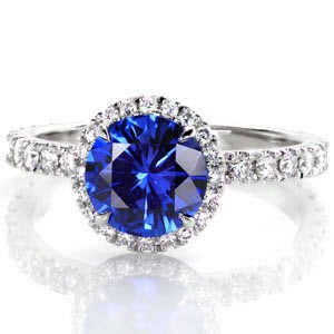 Madison halo engagement ring with blue sapphire center stone and diamond band.
