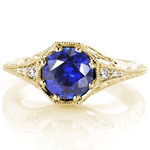 Riverside custom antique inspired engagement ring with a knife edge band and octagonal central bezel holding a round blue sapphire.
