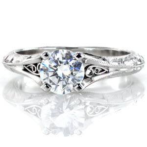 Custom engagement ring in Montreal with a hand engraved knife edge band and filigree curls bordering the center diamond.