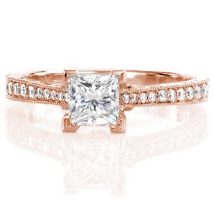 The Princess Vera is an exquisite antique inspired design that features a 0.75 carat princess cut in chevron prongs. Hand engraving, filigree, and milgrain adorn the sides of the ring for a vintage appeal. Micro pavé diamonds graduate in size along the band, giving brilliance and shine to the white gold metal.