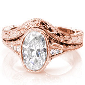 This antique-inspired wedding band is designed to follow the curve of the Rachel Lily engagement ring. The wedding band is elegantly detailed with hand engraved scroll patterns on the top, and a hand engraved half-wheat pattern on the side. A beaded texture called milgrain has been applied to the edges of the piece.