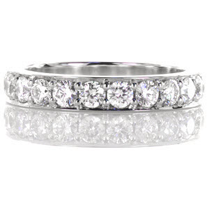 This stunning diamond band contains beautiful stones adding up to a total weight of 1.24 carats. These round brilliant cut stones are set with shared prongs in a 14k white gold band. The luster of the high polished metal compliments the vibrant diamonds.