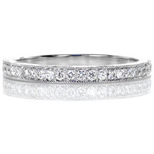 The Vera wedding band design is an antique inspired band designed to compliment our Vera engagement ring. The top is bead set with dazzling round diamonds and the edges are detailed with a beaded milgrain texture. The sides are covered with exquisite hand engraving done in a wave pattern. 