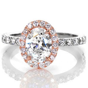 This dazzling two tone design displays a 1.25 carat oval center set inside a brilliant  micro pavé halo. The rich warm color of the rose gold makes the white of the diamonds stand out. The white gold band is also set with vibrant diamonds that compliment the halo.