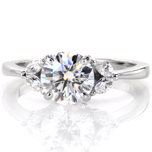 New Orleans custom engagement ring with marquise side diamonds and a round brilliant center stone.