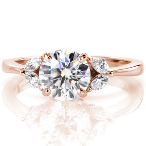 Rose gold engagement ring in Dayton with round center stone and diamond marquise-shaped petals.