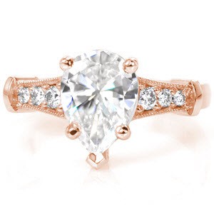 A contemporary diamond engagement ring, Design 2935 features a 1.35 carat pear cut center diamond.The band flares to match the three graduated diamonds on either side of the center stone.The rest of the band is left as a high polished finish which adds a beautiful luster to the piece. 