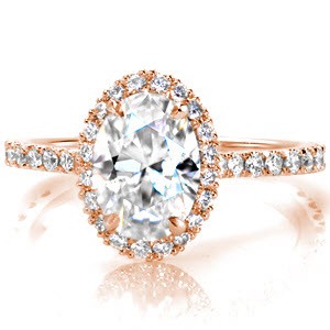 Rose gold engagement ring in Ottawa with oval center stone, diamond halo and micro pave diamonds.