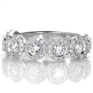 Quebec unique wedding band with seven diamond halos spanning the length of the band.