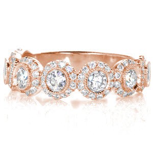 Custom unique wedding rings in Grand Rapids with bezel set round diamond each surrounded by a diamond halo.