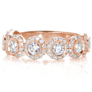 Custom unique rose gold wedding rings in San Diego with bezel set round diamond each surrounded by a diamond halo.