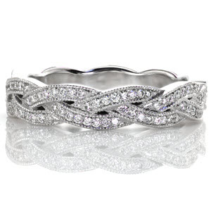 This unique slim woven band is created of seamlessly intertwining elements.  Each segment is elegantly braided with micro pave diamonds and edged with mil-grain texture.  The braided criss-cross design adds dimension to this band. It can be worn as a wedding band or a fashion ring.