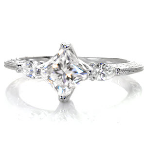 Unique three stone princess cut engagement ring in Sacramento is antique inspired. This stunning engagement ring is set with pear side diamonds and adorned with hand carved relief engraving.