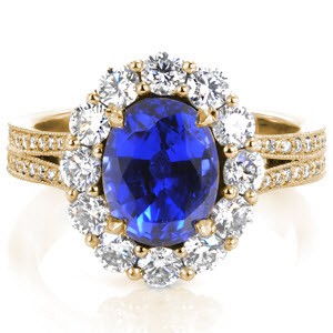 Phoenix custom engagement ting with an oval blue sapphire surrounded by a diamond halo on a split shank band