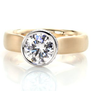 Wide band engagement ring in San Diego with a bezel set round brilliant diamond in two-tone.