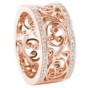 Stunning custom rose gold wedding ring in Salt Lake City, Utah. This gorgeous wide band features a large, filigree scroll pattern reminiscent of Celtic knot work. The edges of the band are set with dazzling micro pave diamonds. 