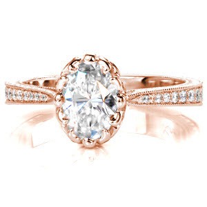 Design 3048 is an exquisite ring with a unique central prong setting featuring a 0.80 carat oval cut stone. The side profile of this piece reveals pierced elements and hand formed filigree curls that highlight the diamond. Graduated diamonds and hand engraving detail the tapered band.