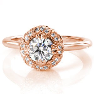 Custom rose gold engagement ring in Pittsburgh with a unique antique inspired halo surrounding a round diamond center stone.