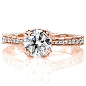 Design 3055 is crafted in 14k white gold and is set with a 1.00 carat round cut diamond. Four pierced prongs are adorned with micro pavé diamonds. Hand formed filigree curls are displayed next to the basket. The hand engraved band presents a vintage appeal that tapers towards the center stone. 