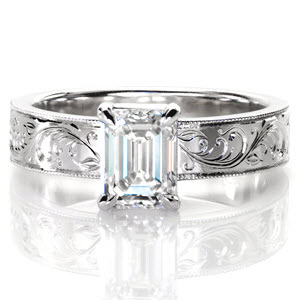 Design 3063 features a regal 1.00 carat emerald-cut central diamond. The long rectangular diamond facets contrast beautifully with its delicately engraved band.   Intricate patterns of hand engraving and textured milgrain edges possess a truly vintage charm. This wide band solitaire is a forever classic.