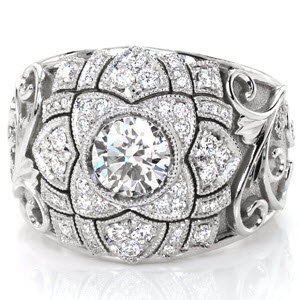 Design 3096 is an intricate tapestry of relief engraving, stippled background and bead-set diamond leaves surrounding a floral-inspired center. This tapered band features a 0.70 carat round brilliant diamond encircled by mil-grain edged micro pavé diamond petal shapes and outlined in scroll hand-engraving.   