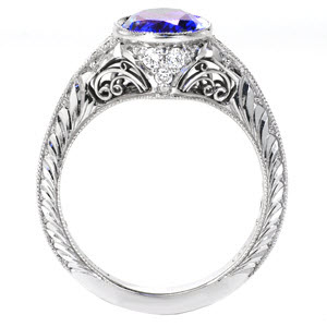 Des Moines unique engagement ring with hand engraving and filigree curls featuring a oval cut blue sapphire.