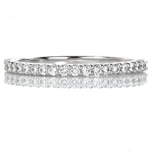 The Alora design is a charming shared prong wedding band shown with round brilliant diamonds spanning half way around the ring. This darling piece provides a lot of sparkle and is a great accent as a wedding or anniversary band. This design is easily customized in other metals to complement any engagement ring.