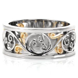 Design 3119 is a lustrous two-tone design shown in 14k white gold and 18k yellow gold. The graceful flow of the filigree pattern creates movement around the ring. The rich, warm hues of the yellow gold stand out beautifully from the cool luster of the white gold as light reflects off of the high polished surfaces.   