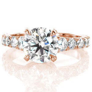 Beautiful rose gold engagement ring in Chicago featuring stunning graduating side diamonds on a flared band. 