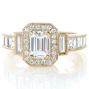 Custom engagement ring in Hartford with an emerald cut center stone surrounded by a bead set diamond halo and baguette band diamonds.