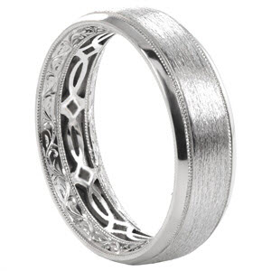 Unique wedding band in Los Angeles features a wide width with a brushed middle and high polished rails. On the inside of the ring, custom antique details were meticulously added by hand. The hand engraved scroll pattern on either side of this eternity band is separated in the middle by a custom decorative inner plate. 