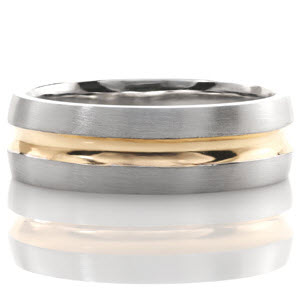 With a high polished yellow gold inlay and a textured white gold band, this gent's ring is the perfect two-tone variation. The yellow gold adds warmth to the cool white gold and creates a dramatic contrast. A hand applied brushed finish is added to the white gold for further effect and detail.