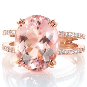 A blushing beauty, this 5.75 carat oval morganite is complemented by the warmth of 14K rose gold. A split shank of glittering prong set micro pavé diamonds draw in focus to the extraordinary center stone. The basket setting and double claw prongs offer both style and security.  