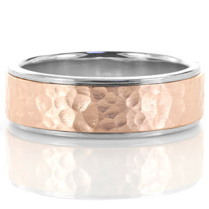 Hand-fabricated in 14k white and rose gold, this design adds a modern twist to a classic style with its mix of metal colors. A brushed finish is applied to the hammered center adding dimension and texture to the pattern. High polished edges frame this wedding band bringing focus to the intricate rose center.   