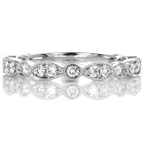 Fine details of milgrain create a delicate outline to Design 3177. A band of alternating shapes including marquise and circles, are decorated with round cut diamonds which are bead set by hand. This band will compliment any style engagement ring and will be a stand out when worn alone.
