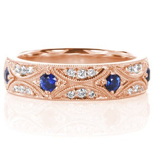 Vancouver rose gold custom band with an intricate pattern of bead set diamonds and blue sapphire outlined with milgrain edging.