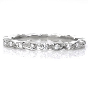 Elegant style continues throughout Design 3222, creating the perfect eternity band.  Crafted in 950 Platinum Ruthenium, this band has bead set round cut diamonds within every marquise shape.  Larger round cut diamonds are prong set between the marquis shapes, creating a scalloped contour.