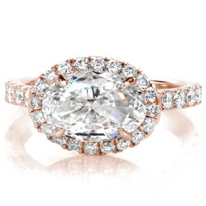 Custom engagement ring in Columbia with a unique horizontal set oval cut center diamond surrounded by a diamond halo and band.