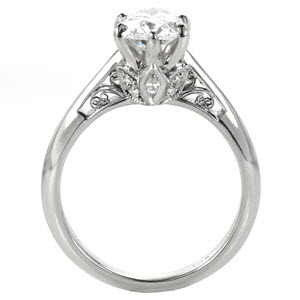 Unique solitaire engagement ring custom created around an oval diamond center held by six prongs with a floral and filigree design profile in Columbia.