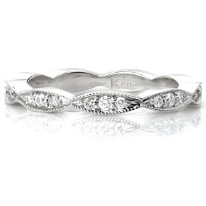 Design 3231 is an elegant scalloped piece that works great as a fun ring, part of a stacker set, or as a wedding band. The beaded milgrain texture along the edges of the band creates a cohesive whole with the beadset round diamonds. High polished sides show off the beautiful luster of the metal. 