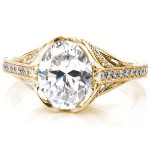Montreal engagement ring with oval center stone and yellow gold diamond setting.
