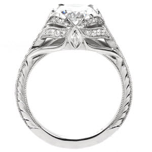 St Louis custom created engagement ring with antique inspired details including center petal prongs holding an oval center and arching bead set diamonds.