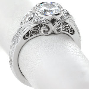 Antique engagement ring in Rochester with filigree, milgrain and bezel set round center.