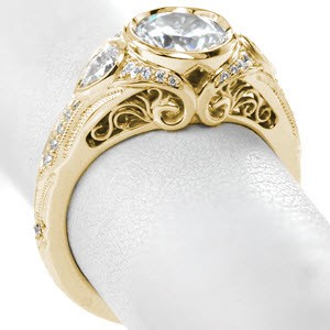 Rose gold engagement ring in St. Petersburg with filigree and bezel set round brilliant diamond.