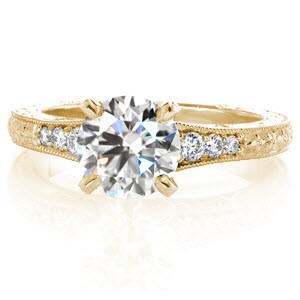 Bradenton antique engagement ring with round brilliant center stone and relief hand engraving.