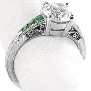 Filigree engagement rings in Milwaukee are a beautiful choice for anyone who enjoys the timeless appeal of vintage techniques. This ring features emerald side stones, hand engraving, and filigree curls.