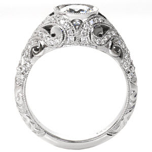 Beautiful art deco engagement ring in Knoxville is a delight of hand carved relief engraving and diamonds in swirl patterns around the bezel set center diamond. 