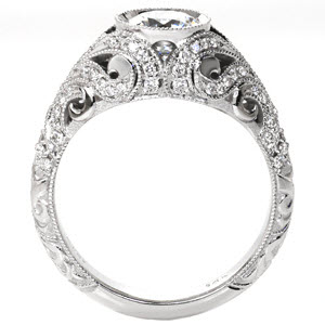 Beautiful art deco engagement ring in Milwaukee is a delight of hand carved relief engraving and diamonds in swirl patterns around the bezel set center diamond. 