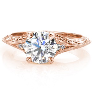 A striking style and detailed adornments create Design 3260. A 1.20 carat round brilliant diamond is set within four low prongs. The flared band has bead set diamonds, hand formed filigree curls and highly intricate relief engraved scrolls. The knife edge band provides the perfect canvas to view the full engraving.